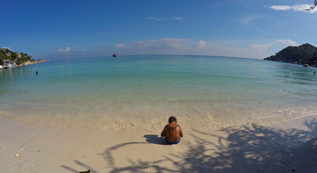 Noah enjoying one of the beaches with crystal clear water in the paradise island of Koh Tao, Thailand